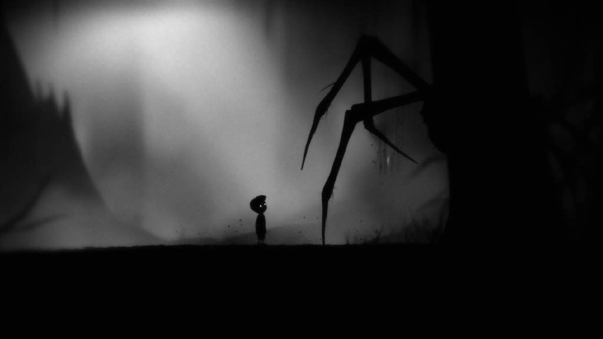 A small boy approaches a spider-like being in the dark