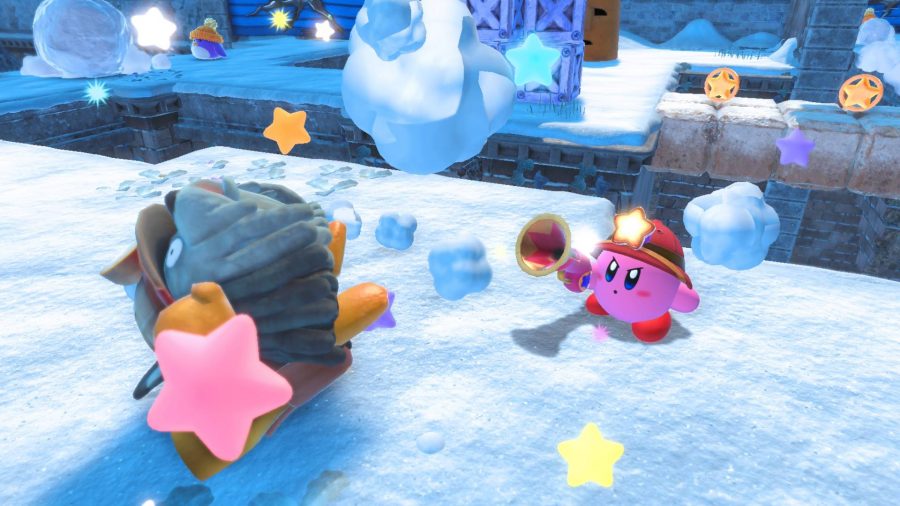 Kirby shoots an enemy on an ice level, wearing a silly little hat 