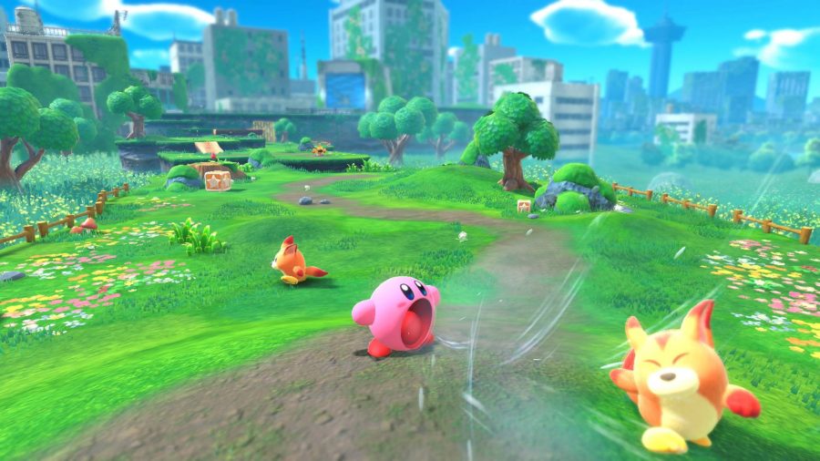 Kirby inhales enemies in a wide-open green level