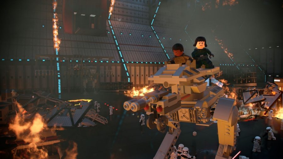 Finn and Rose atop a walker belonging to the Empire, walking through destroyed ships and robots on a big ship.