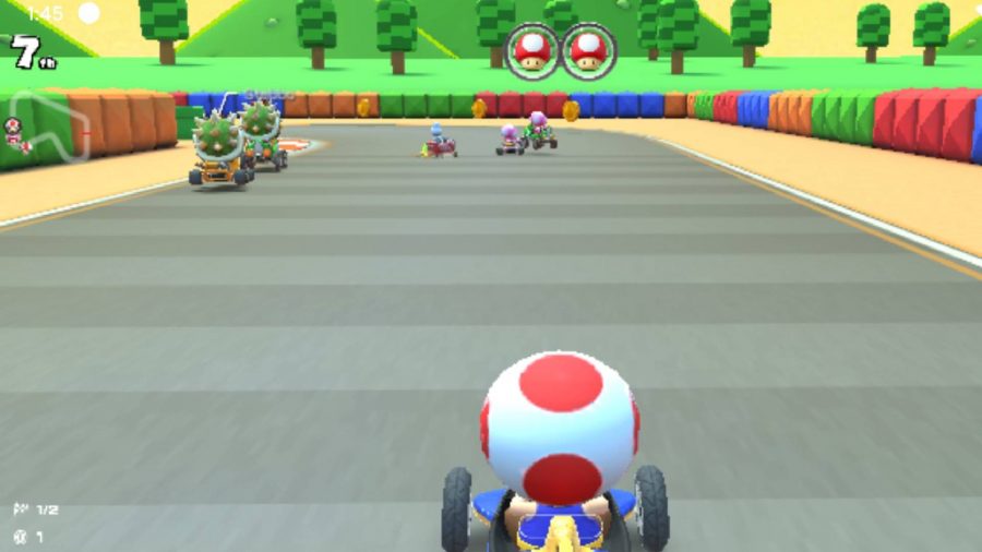 A csreenshot from Mario Kart Tour shows Toad driving along a track 