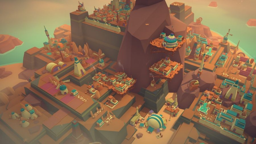 A screenshot from Islanders, showing various houses built into the cliffside.