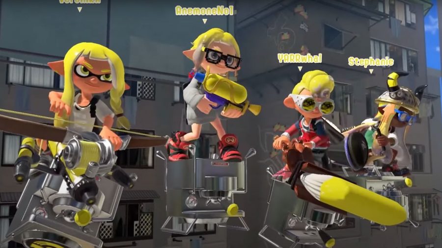 Four Splatoon characters floating on cubes, all with yellow hair and wacky clothing.