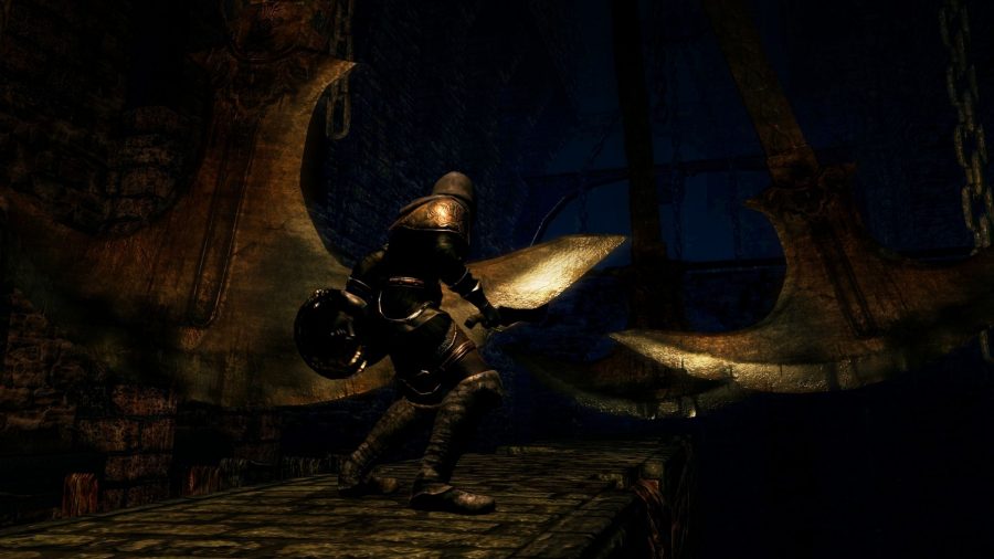 A Dark Souls character traverses a walkway with swinging axes above it.