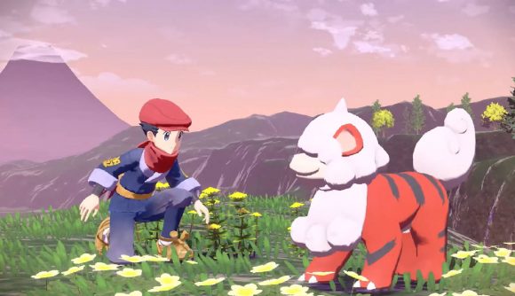 Pokemon Home 2.0 Update: A pokemon trainer crouches down to approach a Hisuian Growlithe