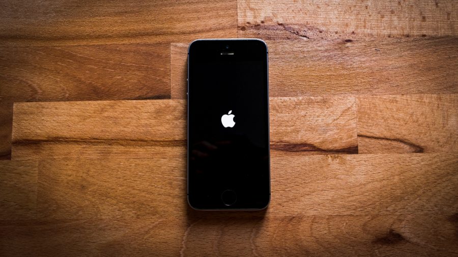 Best VPN for iPhone - an image shows an iPhone sitting on a wooden surface.
