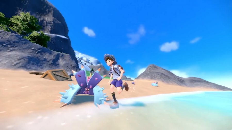 A Pokémon trainer running along a beach
