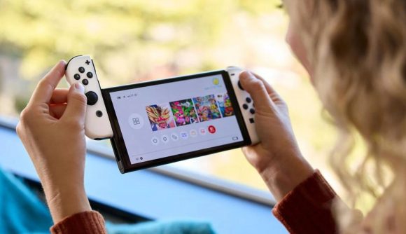 A blonde woman playing a Nintendo Switch, attaching the right controller to the side of the console.