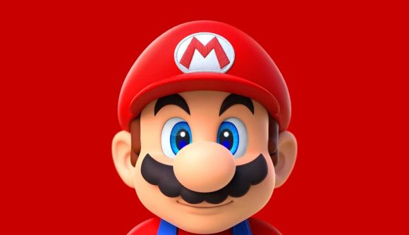 A picture of Mario (a cartoon man with a large bushy moustache, big blue eyes, and a red cap with an M on it). He's looking straight at the camera and is stood against a red background.