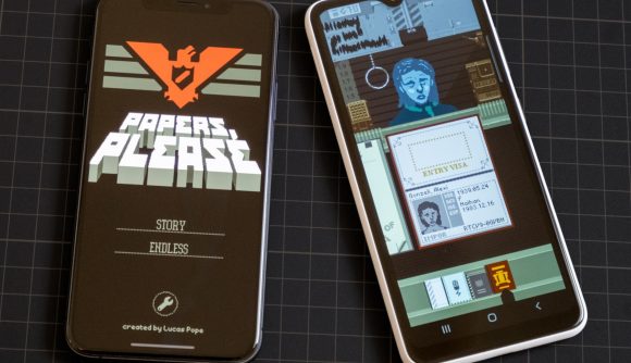 Two phones lay flat next to each other with the game Papers Please running. on the left is the title screen, showing the Soviet propaganda-style poster and menu options. On the right is mid-game, showing a passport laid out, a pixel-art character, and other menu options.
