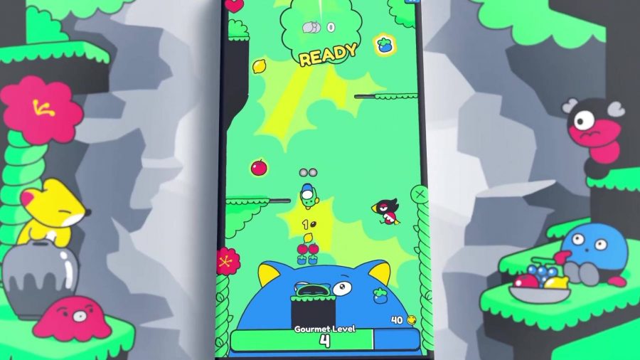 Poinpy review: A little blue ball of a guy aims to jump upwards, with several fruit visible and a giant blue cat at the bottom of the screen