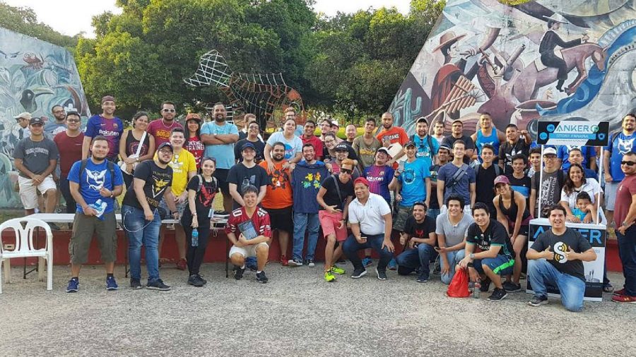 Pokemon Go sixth anniversary interview: a photo shows dozens of players gathered toegther, all playing Pokemon GO