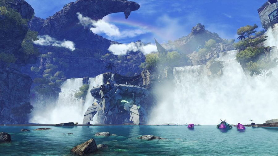A wide shot of Xenoblade Chronicles 3, showing two waterfalls falling into a large lake. In between the two is a large white mech. In the sky, the land reaches up into the sky, silhouetted. The sky is blue and cloudy.