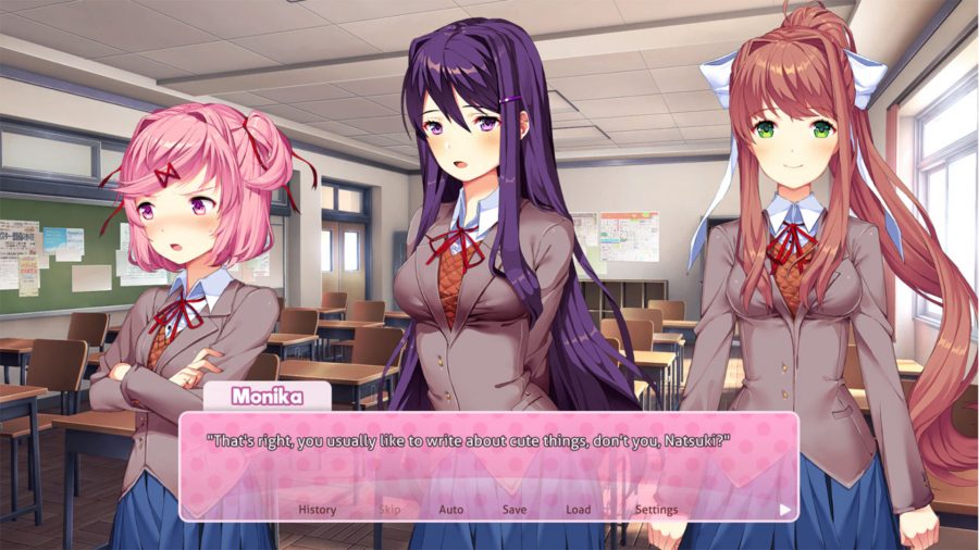 Girl gamees - three female stood in a classroom with a text box in front of them