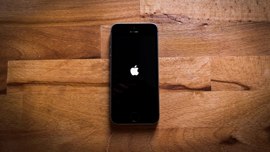 How to delete albums on iPhone - an iPhone on a wooden floor